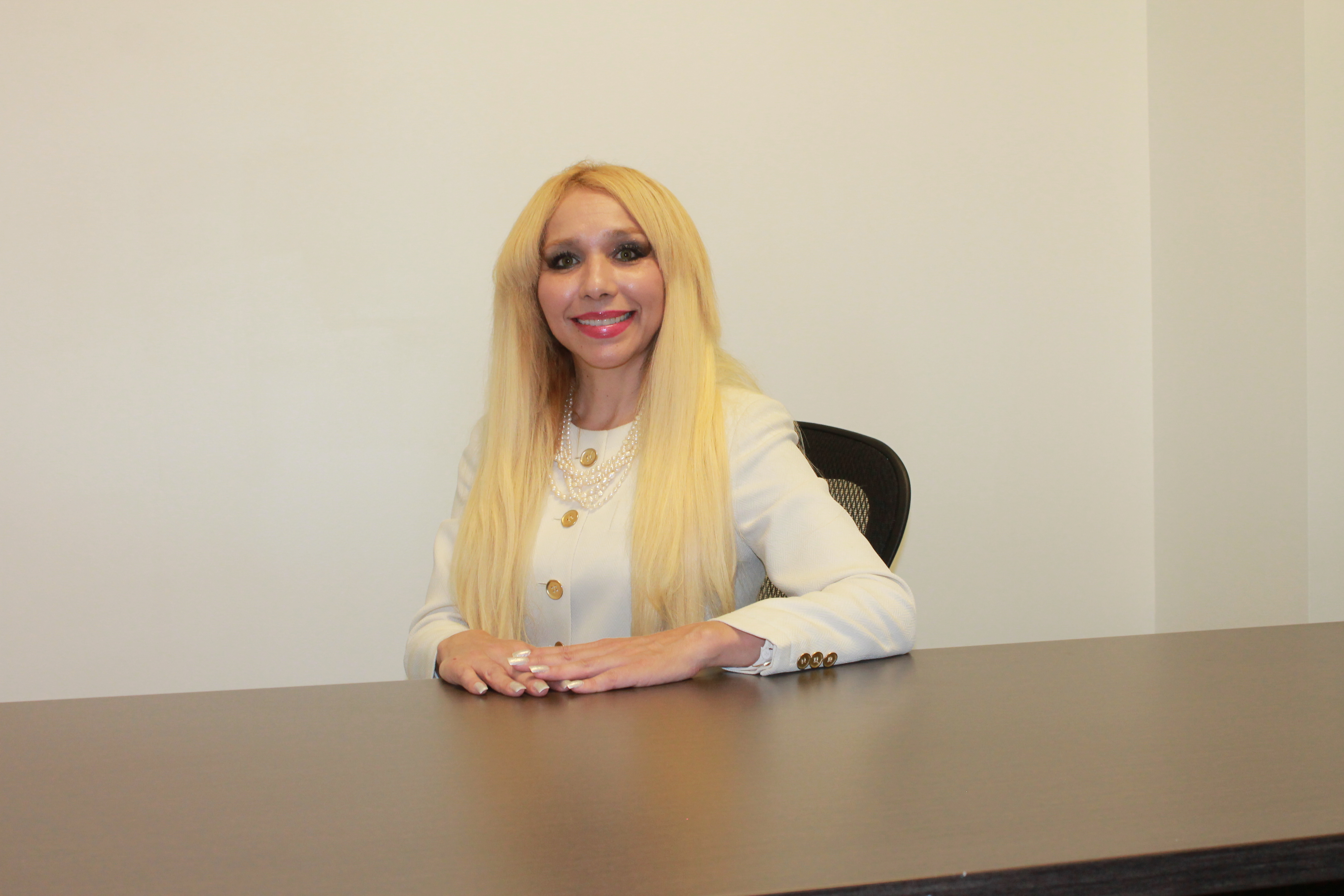 Attorney Elena Medina Torres seated at her desk